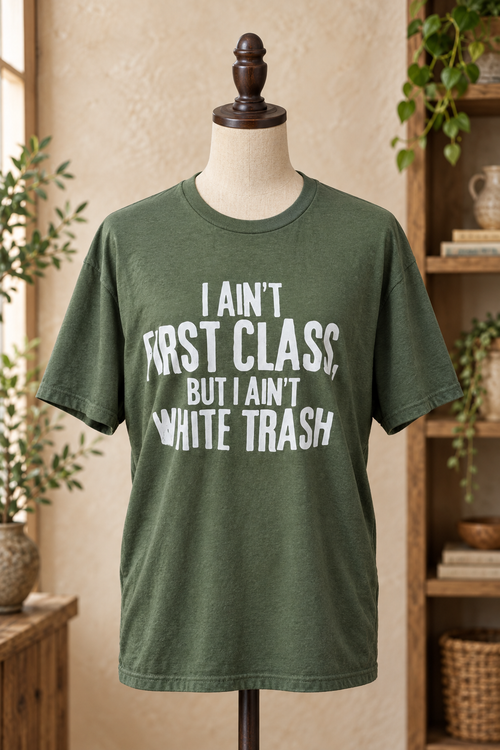 Military-green graphic tee displayed on a mannequin in a rustic boutique setting